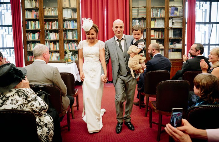 bride and grrom walking down the aisle in the council chamber in temple of peace