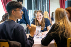 young people negotiate at a table 