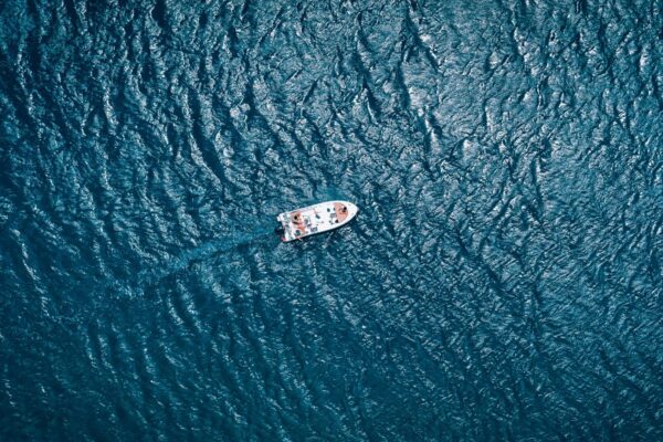 A boat sails on a wide ocean
